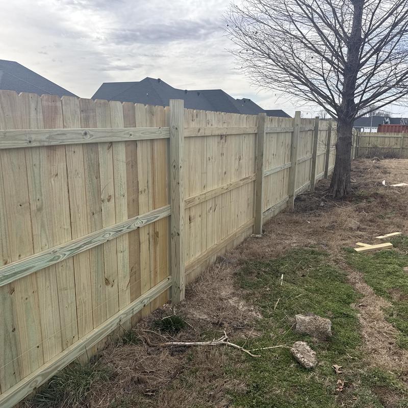 Wooden privacy fence installation after wind damage