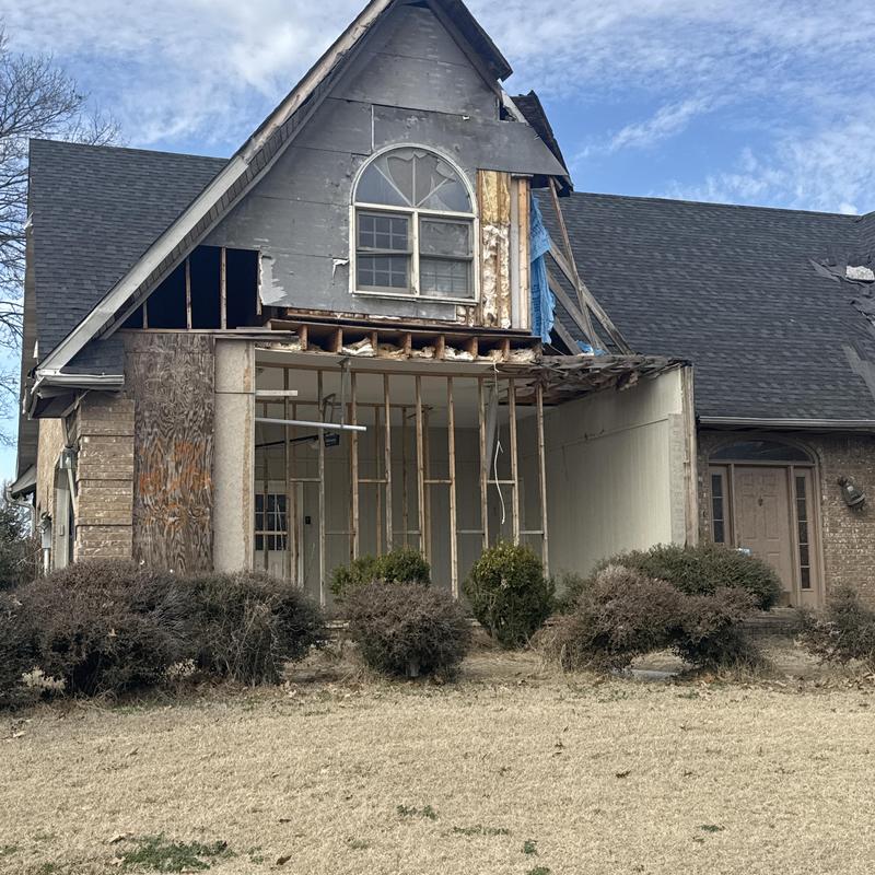 Roof framing and exterior wall damage from tornado