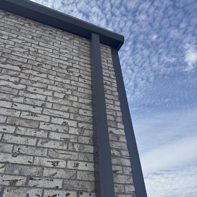 Metal flashing installation on brick wall edge