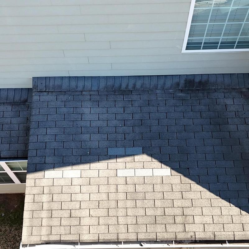 Asphalt shingle roof with visible wear and missing shingles
