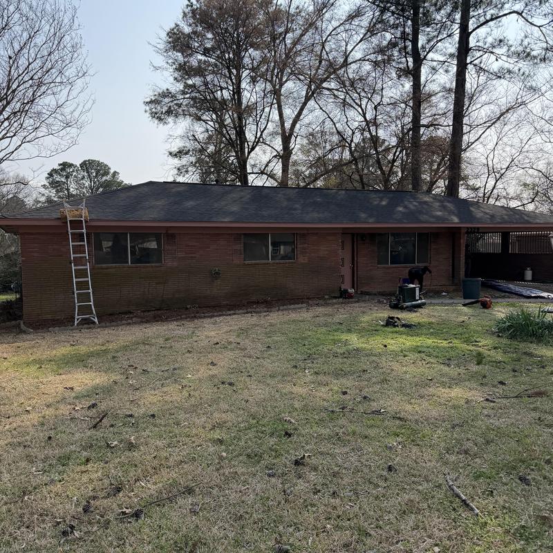 Asphalt shingle roof installation on brick house