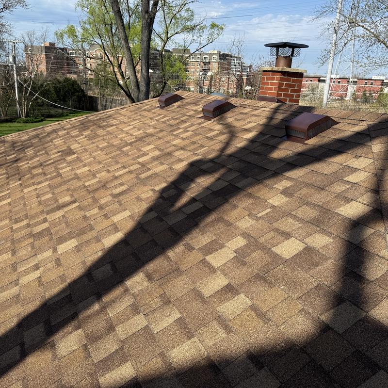 Asphalt shingle roof with vents and brick chimney