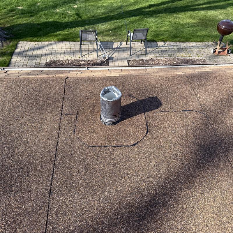 Asphalt roof vent pipe with marked repair area