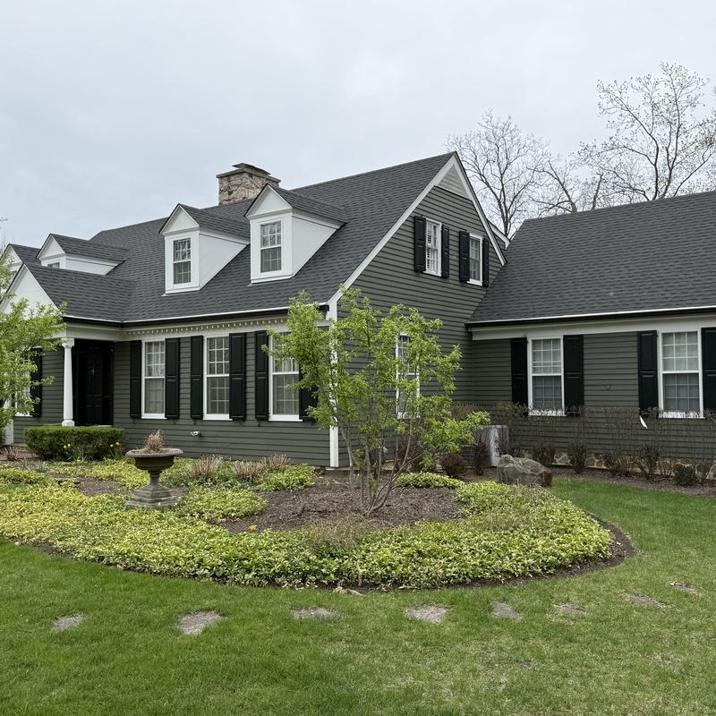 Gutter guards installed on dark gray house exterior