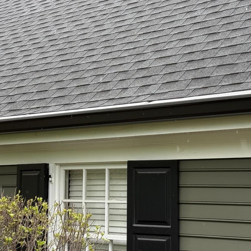 Gutter guards and roof shingles on residential home.