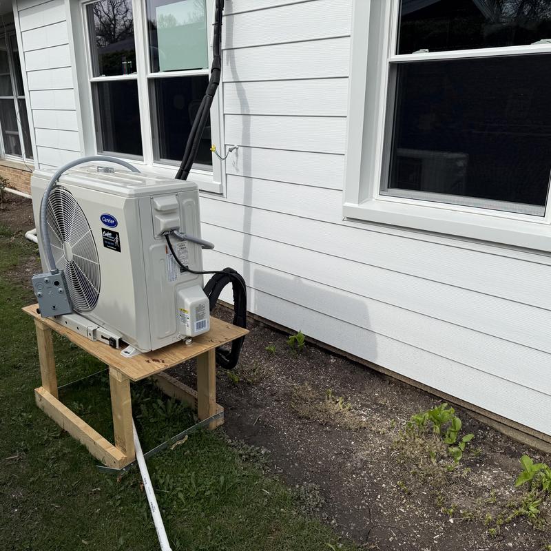 Mini-split air conditioner unit by insulated siding