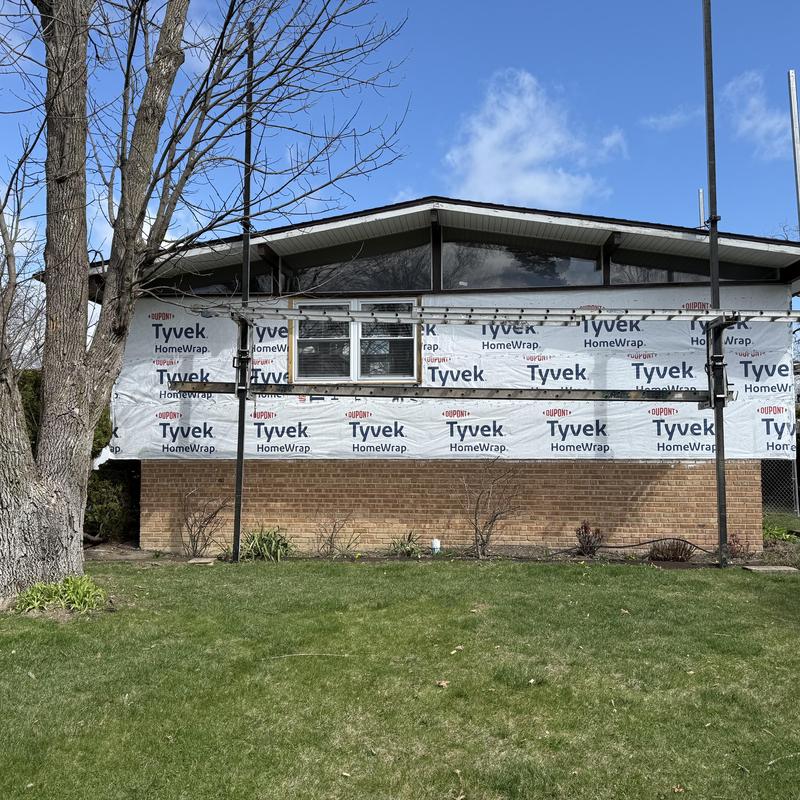 Composite insulated siding installation with window framing
