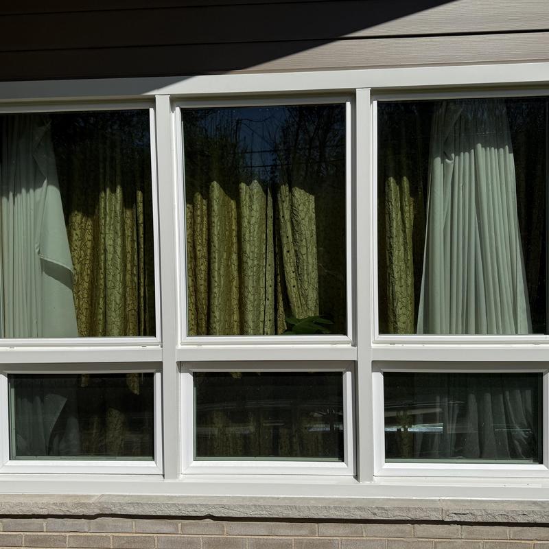 Composite insulated siding with white window frames