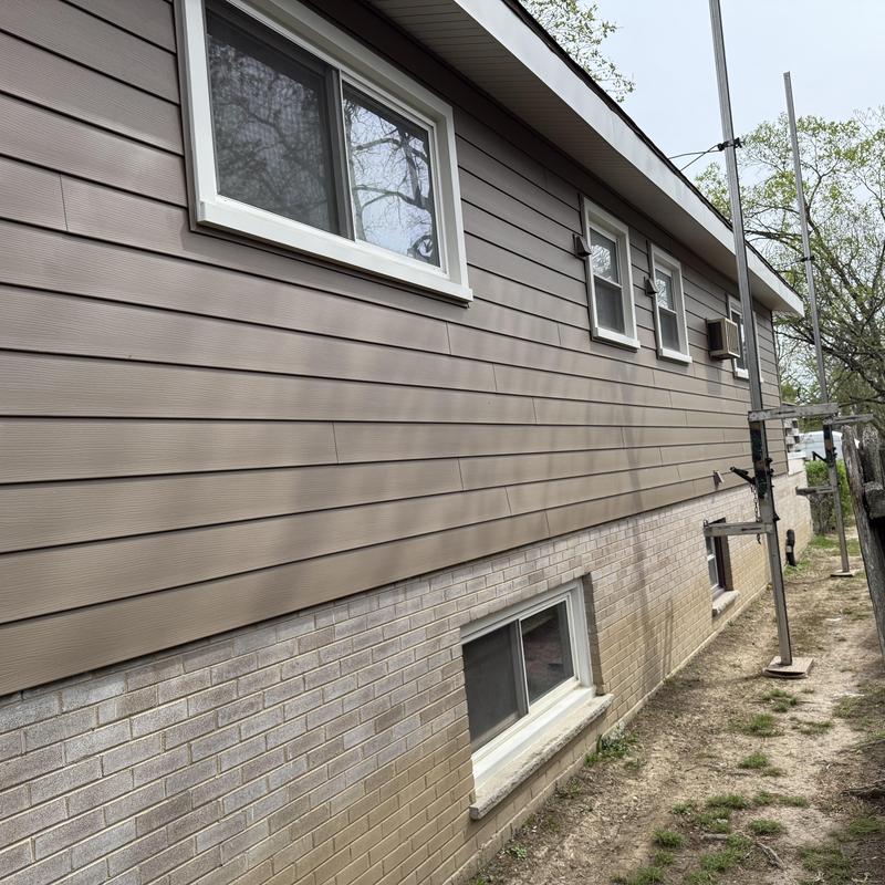 Composite insulated siding on residential exterior wall
