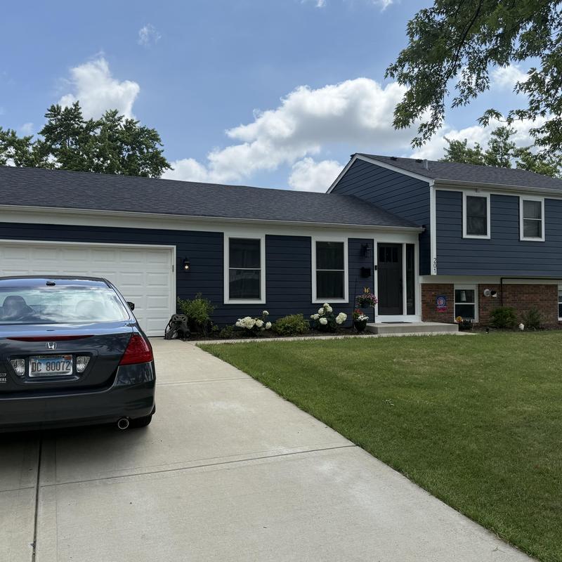 Composite insulated siding and entry door on house exterior