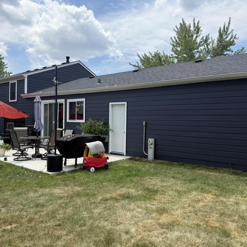 Composite insulated siding and white entry door exterior