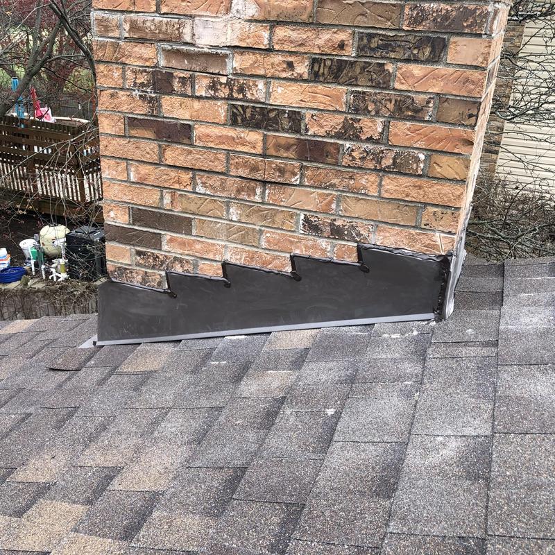 Chimney counter flashing installation on asphalt roof shingles