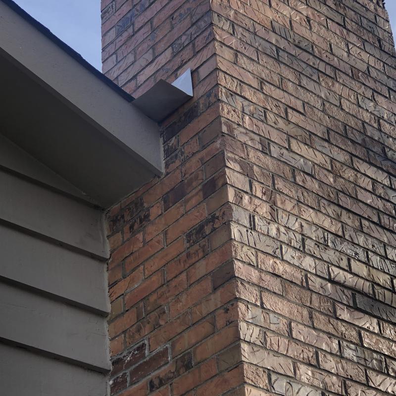 Brick chimney flashing on roof edge in Naperville