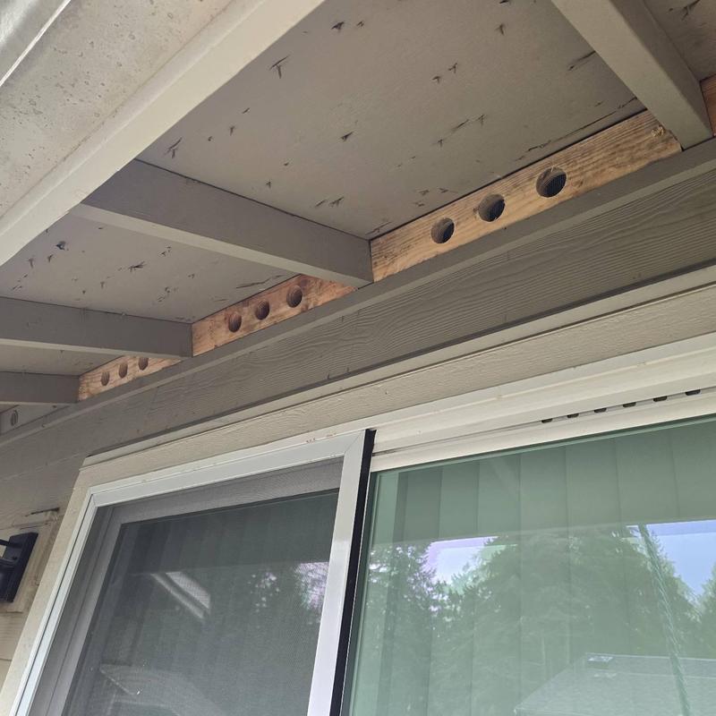 Soffit vent blocks with wood support repairs above window