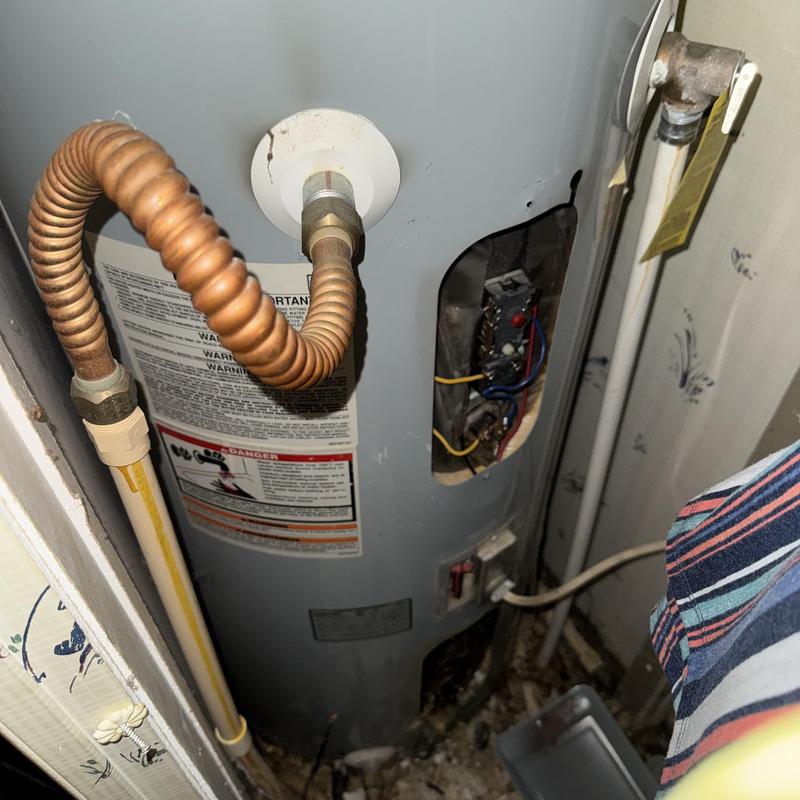 Water heater with gas line and electrical panel exposed