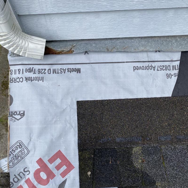 Roof flashing and shingle installation near drainpipe