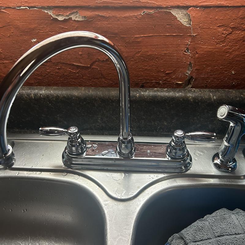 Kitchen faucet with sprayer on stainless steel sink