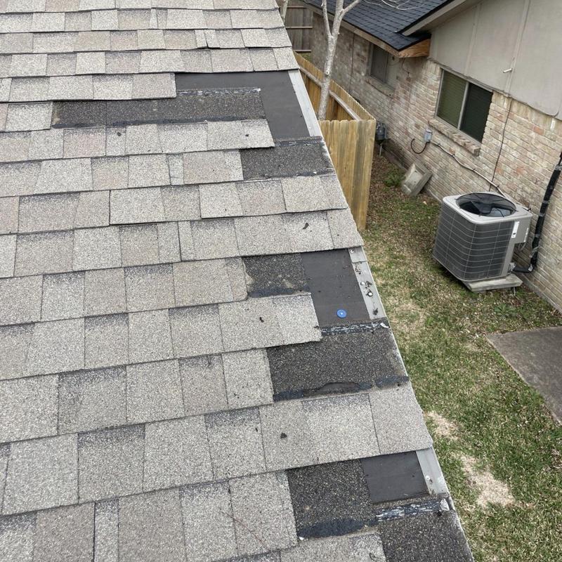 Architectural shingles missing on roof edge near gutter