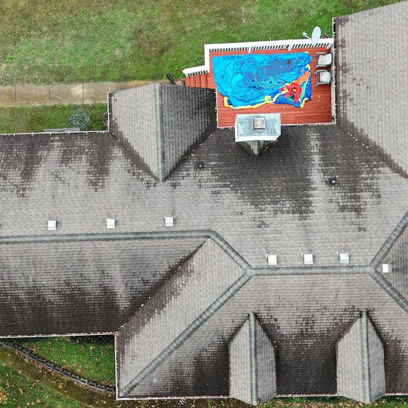 Asphalt shingle roof with ridge caps and deck area