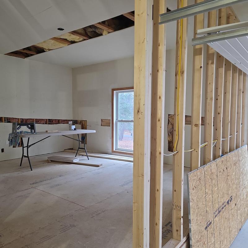 Interior structural framing with drywall installation in progress