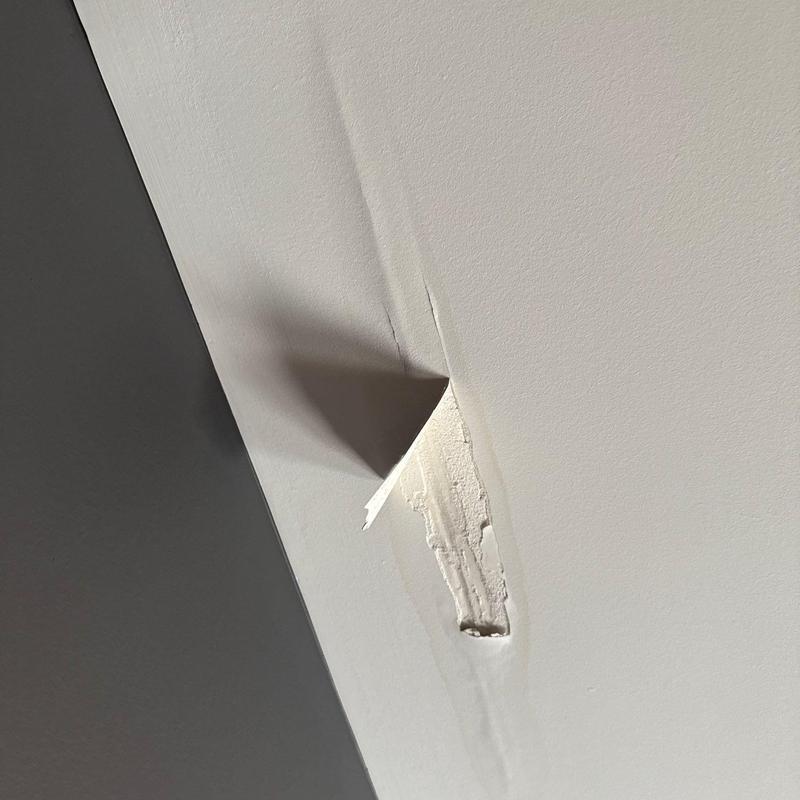 Drywall ceiling with water damage and peeling paint