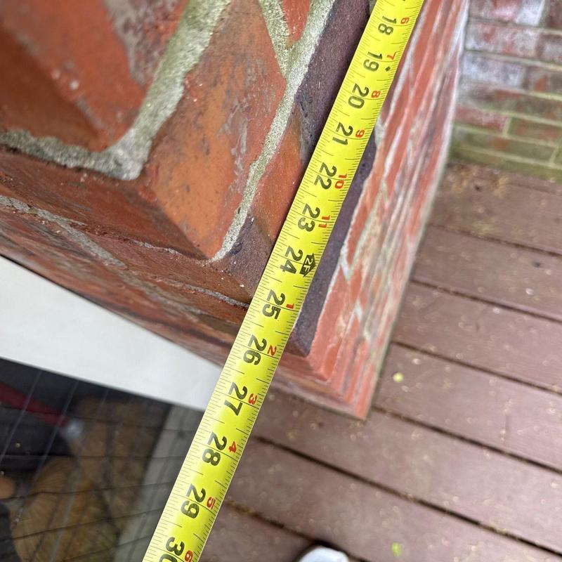 Brick wall corner with tape measure reading 26 inches