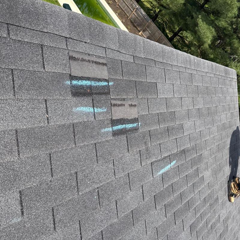 Asphalt shingle roof with hail damage markings