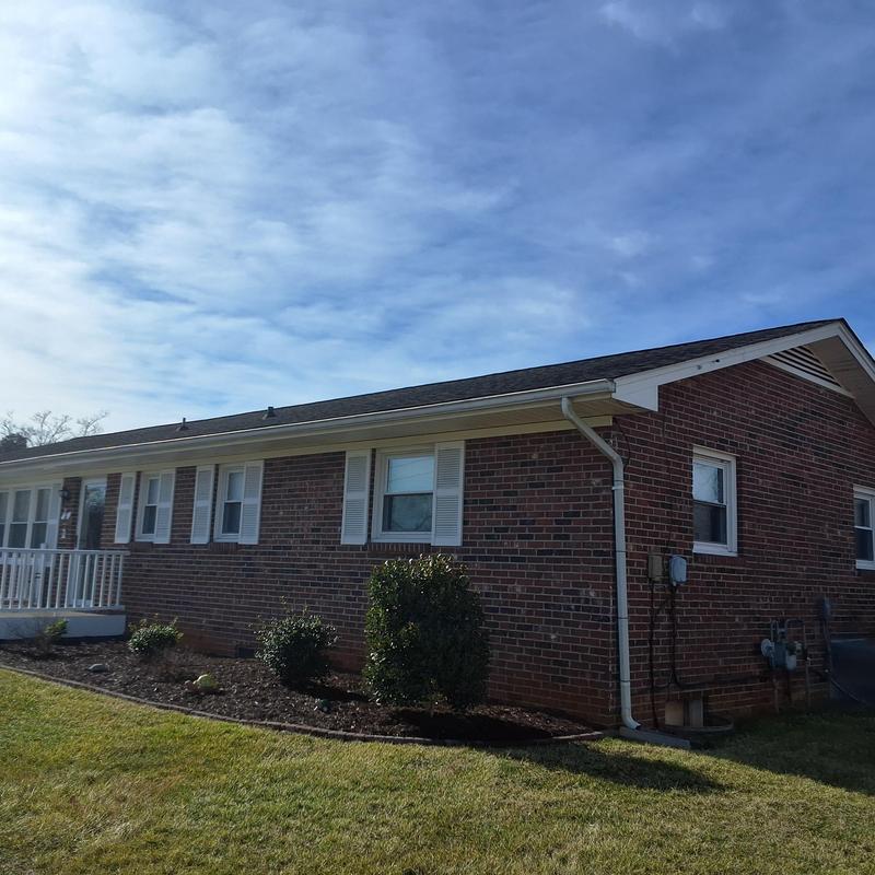 Asphalt shingle roof with visible wear and damage