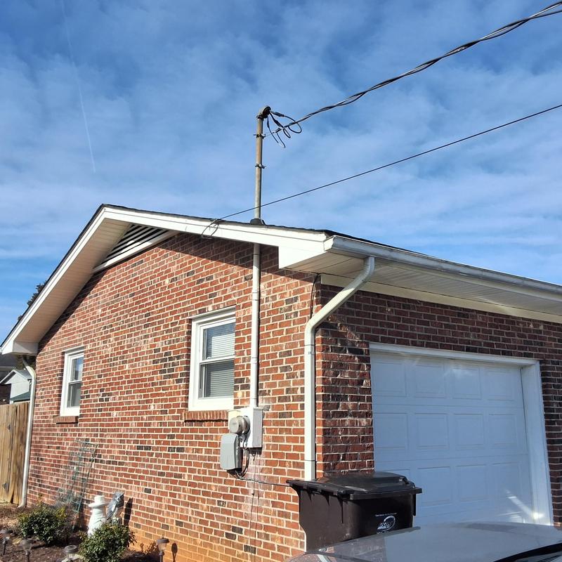 Brick exterior wall with electrical meter and wiring