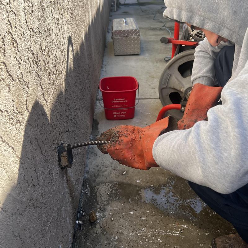 Outdoor drain cleaning with drain snake tool