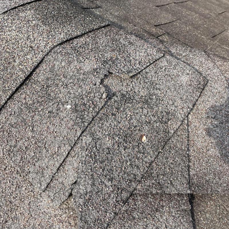 Asphalt shingles with granule loss and cracking damage
