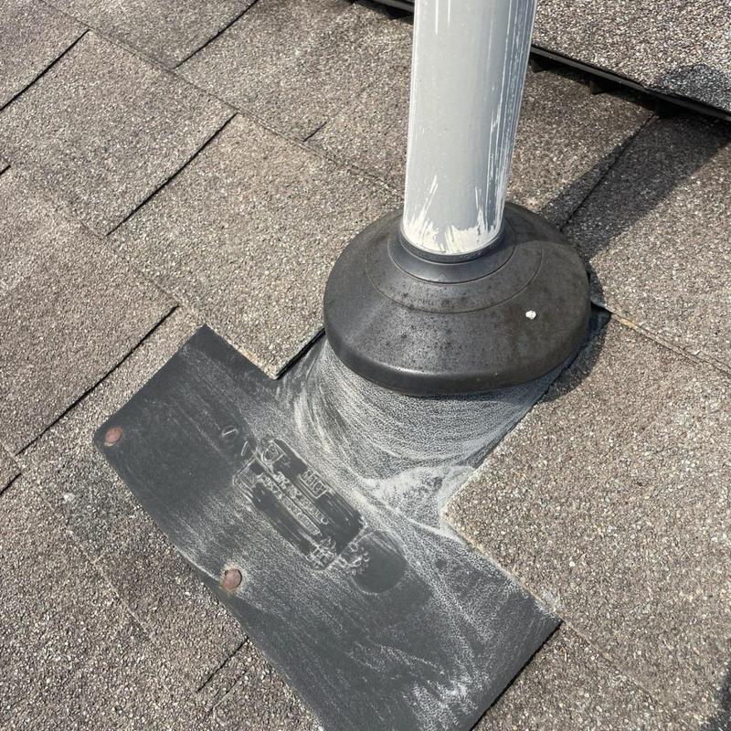 Aging pipe boot flashing with roof shingle wear
