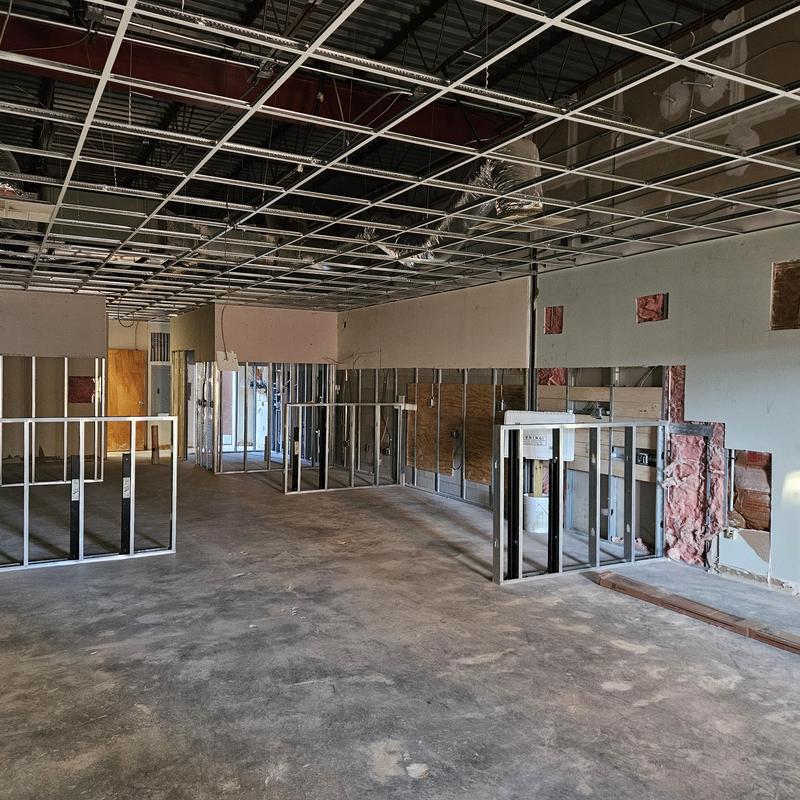 Ceiling grid and metal stud framing installation in retail space
