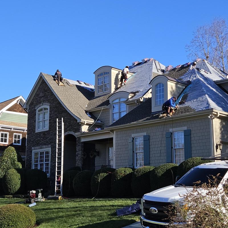 Roofing shingles removal and replacement in progress