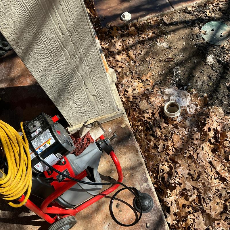 Main sewer line drain machine beside yard cleanout pipe Main sewer line drain machine beside yard cleanout pipe