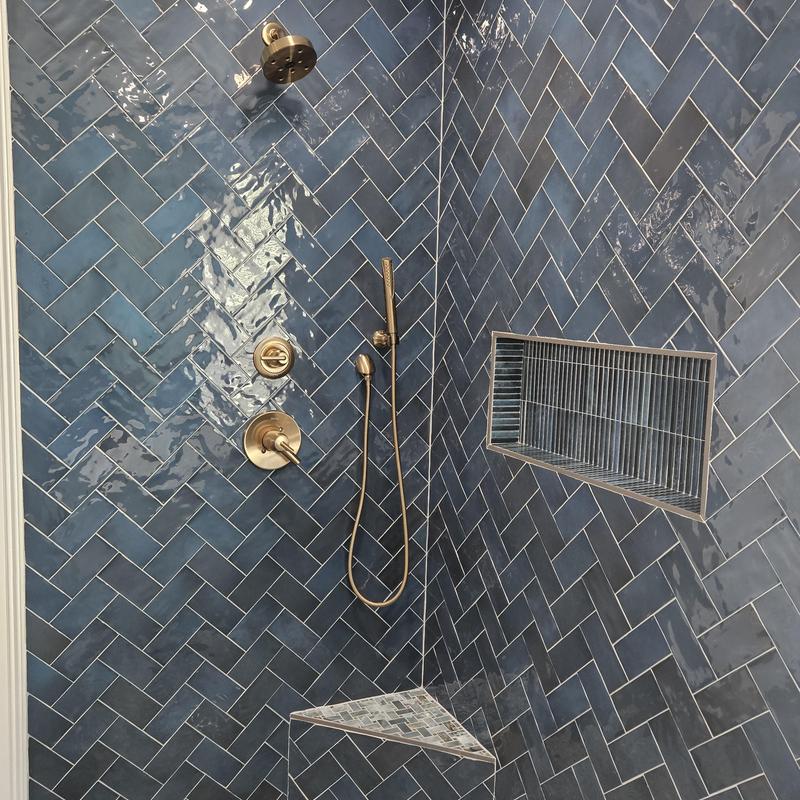 Shower system with blue herringbone tile and niche Shower system with blue herringbone tile and niche