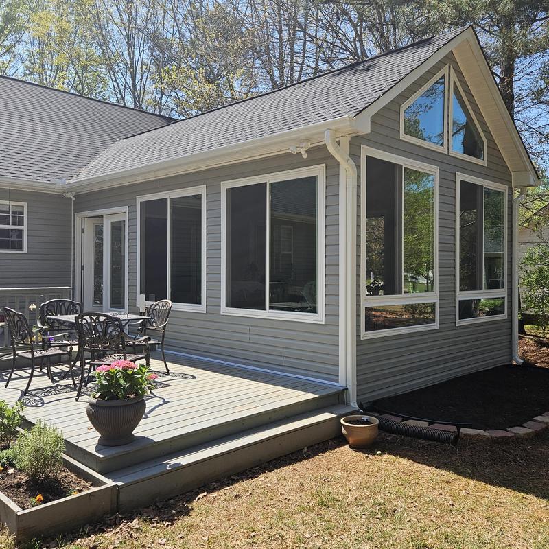 Sunroom addition with large windows and deck