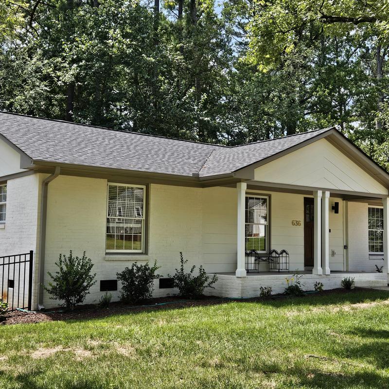 Asphalt shingle roof and exterior siding on renovated home Asphalt shingle roof and exterior siding on renovated home