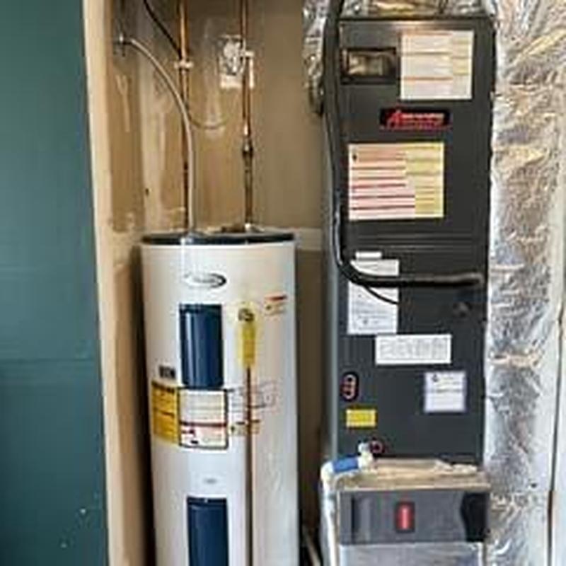 50 gallon electric water heater next to HVAC unit