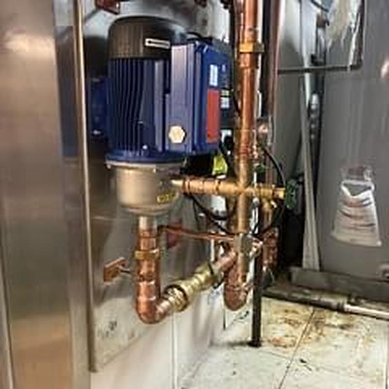 Booster pump with copper piping in mechanical room