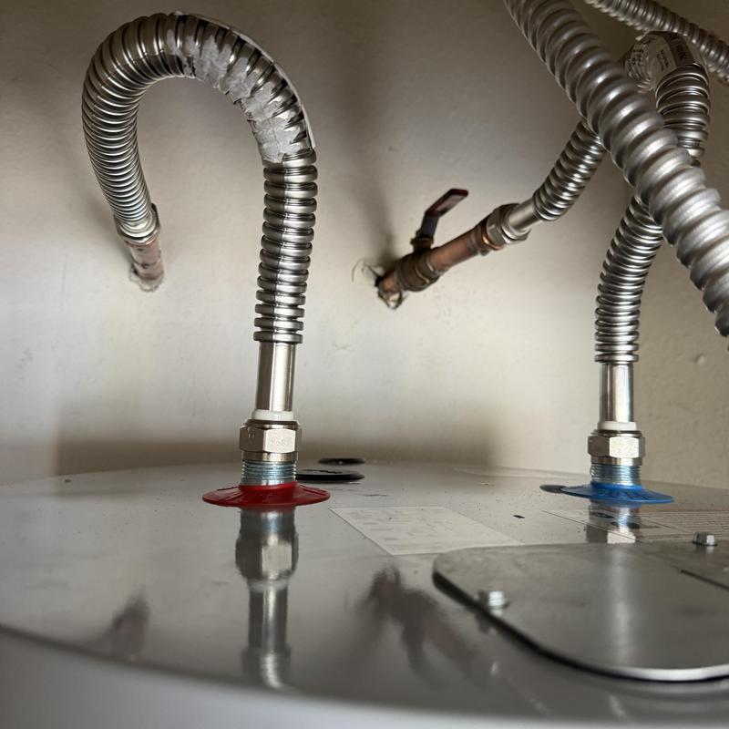 Electric water heater with new supply lines and valves