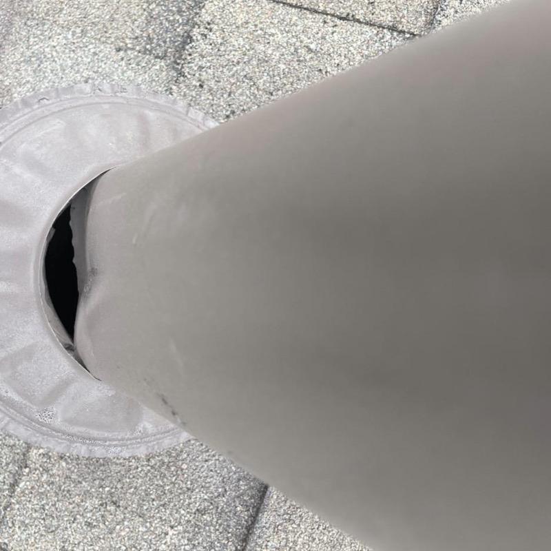 Roof pipe vent with damaged flashing on shingle roof