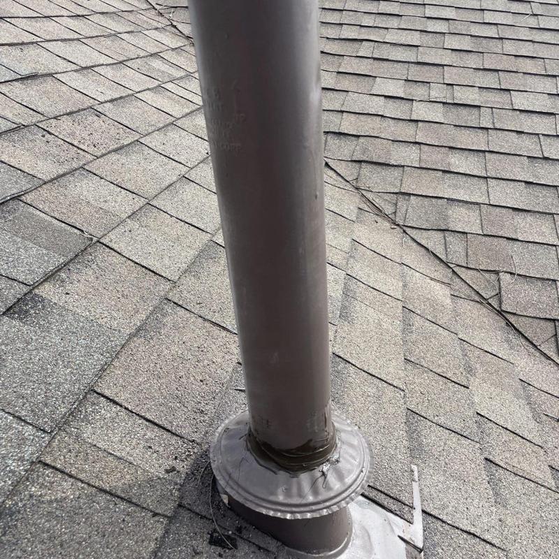 Plumbing vent pipe flashing on asphalt shingle roof