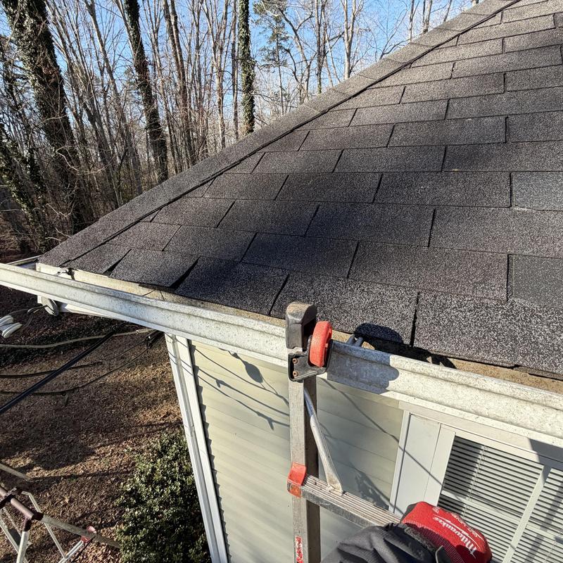 Metal gutters and fascia with ladder at roof edge