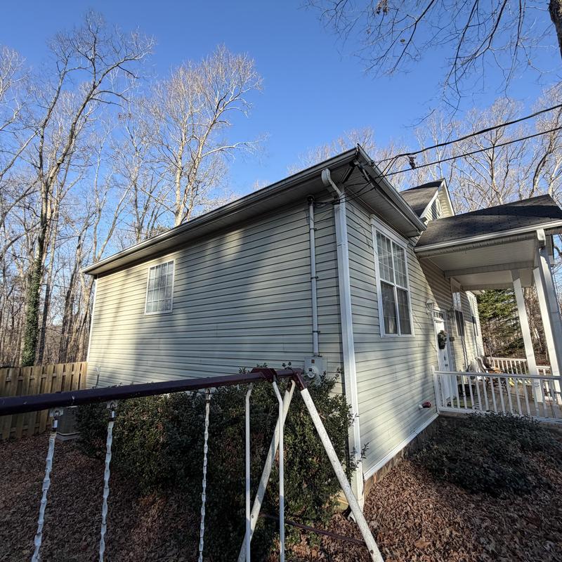 Power line with damaged fascia and gutters on house exterior