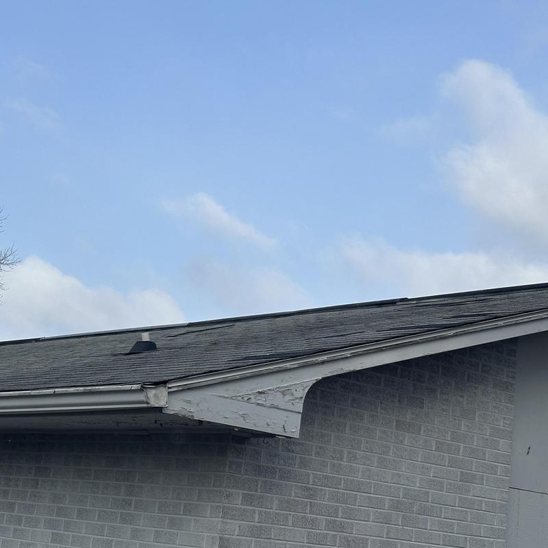 Asphalt shingle roof with visible wear and damage