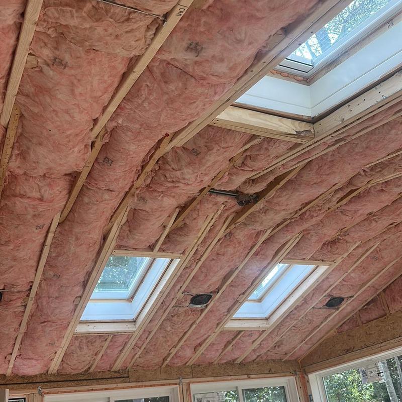 Roof insulation installation with skylight framing