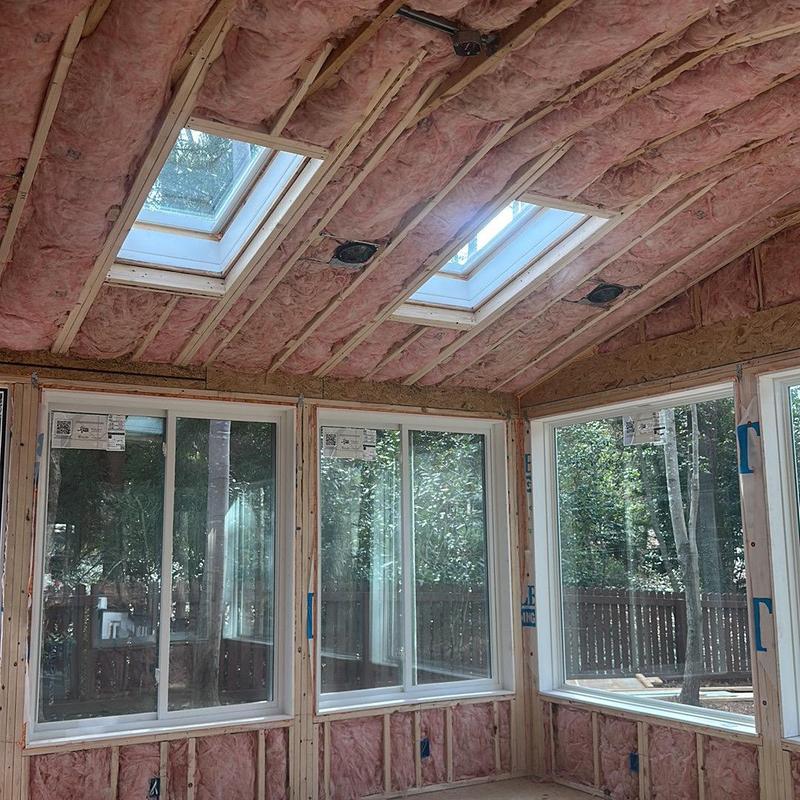 Fiberglass attic insulation installed around windows and skylights