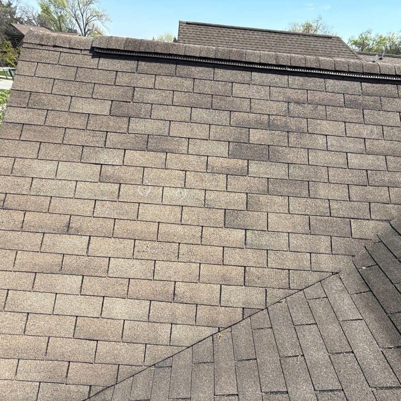 Asphalt shingle roof with hail damage and ridge cap inspection