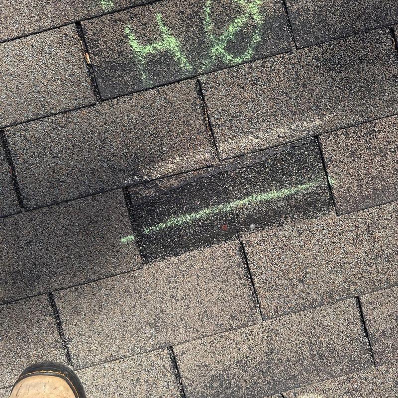 Asphalt shingles with hail damage and chalk markings